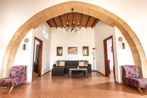 a living room with a couch and two chairs at Casa Theoni in Kattavía