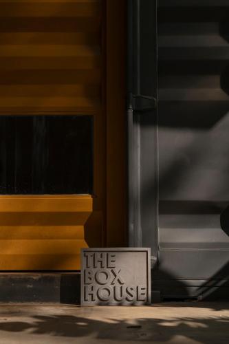a sign that says the box house in front of a door at The Box House in Tangalle