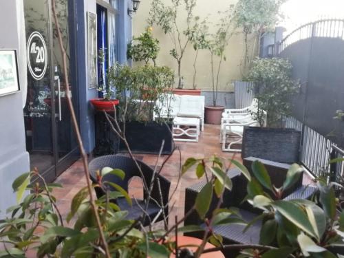 a patio with chairs and plants on a house at Al 20 Guest House Fiera Milano - Certosa - San Siro in Milan