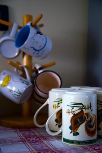 two coffee mugs with a dog on them on a table at Sant'Andrea Agriturismo con cantina Martignago Vignaioli Asolo Prosecco Docg Wines in Maser