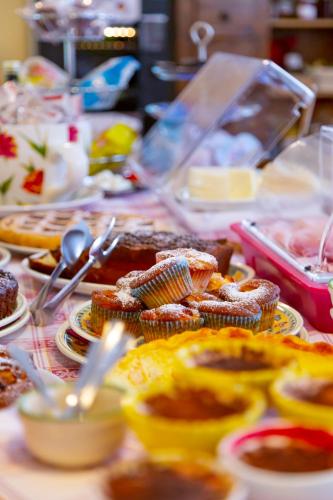 a table topped with plates of food and desserts at Sant'Andrea Agriturismo con cantina Martignago Vignaioli Asolo Prosecco Docg Wines in Maser