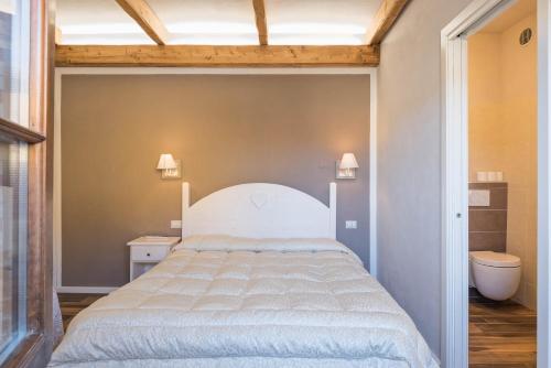 a bedroom with a large bed and a bathroom at Locanda Zita in Sestola