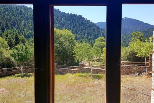 a window with a view of a mountain at Elati Hills in Vytina