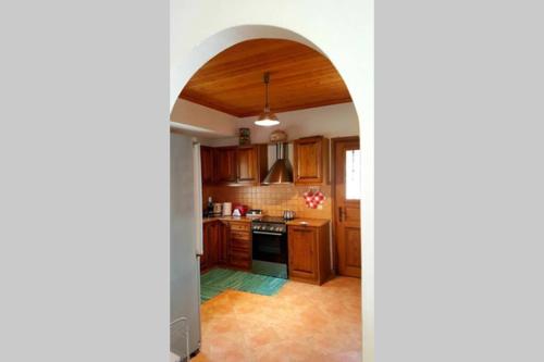 a kitchen with an archway leading into a room at Elati Hills in Vytina