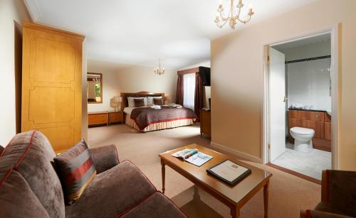 a living room with a couch and a bed at Best Western Hotel de Havelet in St Peter Port