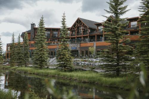 a large building with trees in front of it at The Malcolm Hotel in Canmore