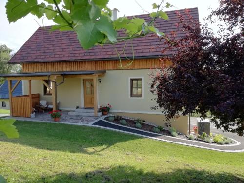 a small white house with a red roof at Ferienhaus Penitz in Großklein