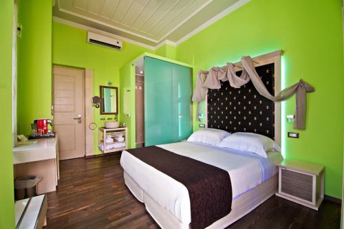 
a bedroom with a bed and a dresser at Elia Fatma Boutique Hotel in Chania Town
