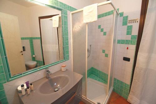 a bathroom with a sink and a shower at Sa Mirada Apartments in Villasimius