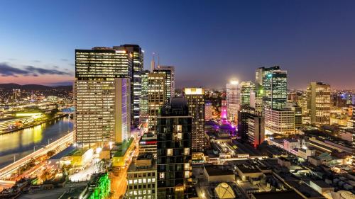 a view of a city at night with buildings at Oaks Brisbane Casino Tower Suites in Brisbane