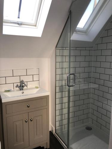 a bathroom with a shower and a sink and a shower at The Dorrington in Halstead