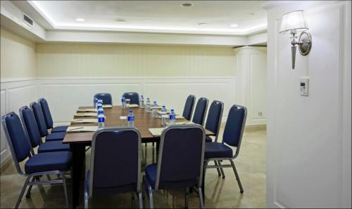 a conference room with a long table and blue chairs at Dosso Dossi Hotels Old City in Istanbul
