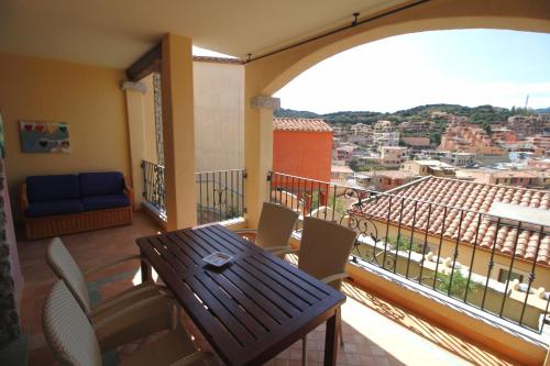 a balcony with a table and chairs and a view at Sa Mirada Apartments in Villasimius