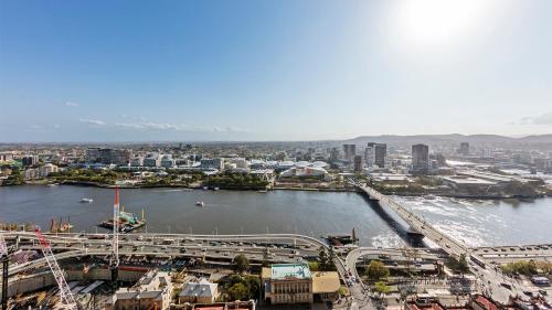 a view of a city with a river and a bridge at Oaks Brisbane Casino Tower Suites in Brisbane