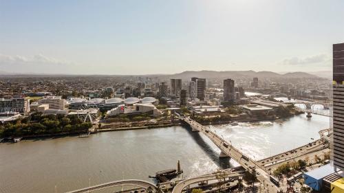 a view of a city with a river and a bridge at Oaks Brisbane Casino Tower Suites in Brisbane