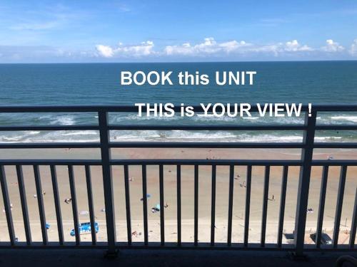 a sign that reads book this unit this is your view of the beach at Ocean Walk Resort - Fabulous Ocean Front View in Daytona Beach