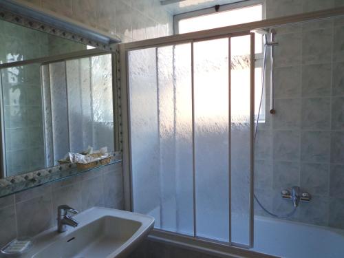 a bathroom with a shower and a sink and a window at Hotel Select in Montecchio Emilia
