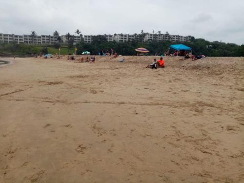 a group of people sitting on a beach at Stesh Margate Holiday House 12 Sleeper in Margate