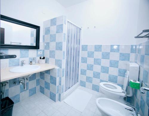 a bathroom with a toilet and a sink at B&B Colors in Sellia Marina