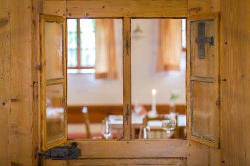 an open window in a wooden room with a table at Bett in der Wies´n, Restaurant Triad in Bad Schönau