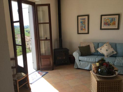 a living room with a blue couch and a fireplace at Viaggio della Vita B&B in Fontanile