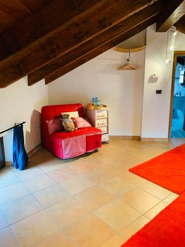 a living room with a red couch and a dresser at Viaggio della Vita B&B in Fontanile