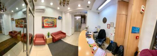 an office with a waiting room with a desk and chairs at Artemision in Athens