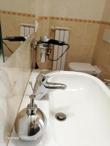 a bathroom with a white sink and a toilet at bariairport in Bari