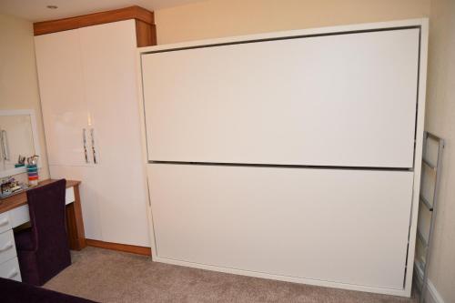 a large white sliding door in a room at Lauriston & Lawton Court Hotel in Llandudno