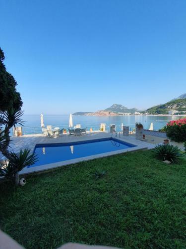 a swimming pool with a view of the ocean at Vila Fortuna in Sutomore