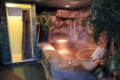 a bath tub in a room with a sink at Don Q Inn in Dodgeville