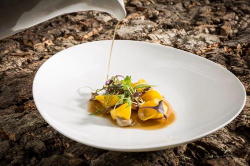 a white plate with food on a table at Triad Ferienhäuschen Stöckl in Bad Schönau