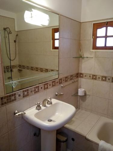 a bathroom with a sink and a mirror at RIO y VERDE in Córdoba