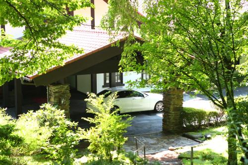 a white car parked in front of a house at Tateshina Tokyu Hotel in Chino