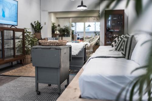 a room with two beds and a table with a television at 3Bedrooms City Nimman in Chiang Mai