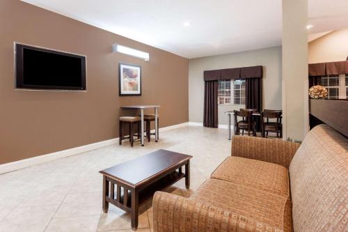 a living room with a couch and a table at Microtel Inn & Suites by Wyndham Macon in Macon