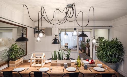 a dining room with a table and a chandelier at 3Bedrooms City Nimman in Chiang Mai