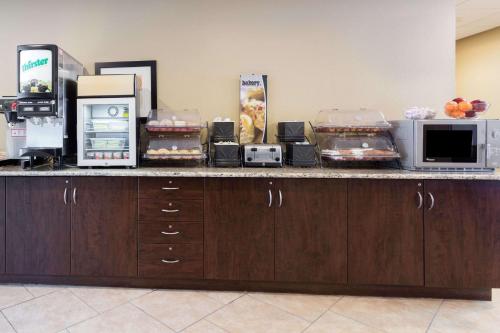 a kitchen counter with microwaves and food on it at Microtel Inn & Suites by Wyndham Macon in Macon