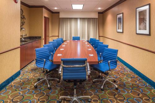 a conference room with a long table and blue chairs at Holiday Inn Express Hotel & Suites Manchester - Airport by IHG in Manchester