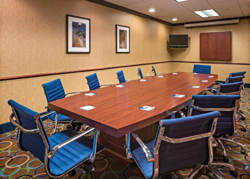 a conference room with a large wooden table and chairs at Holiday Inn Express Hotel & Suites Manchester - Airport by IHG in Manchester