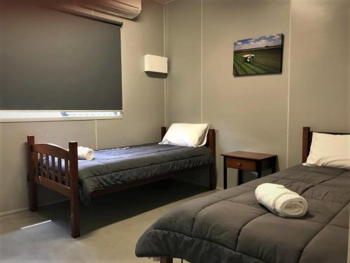 a room with two beds and a large screen at Lake Callide Retreat in Biloela