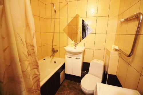 オレンブルクにあるАпартаменты на пр Победы OrenRoomのバスルーム(トイレ、洗面台、バスタブ付)