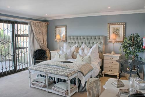 a bedroom with a large bed with white pillows at Mt Bijoux Preferred Accommodation in Bloubergstrand