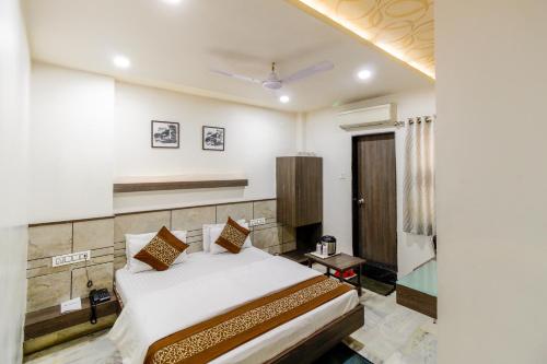 a hotel room with a bed and a shower at Hotel City Inn in Ahmedabad