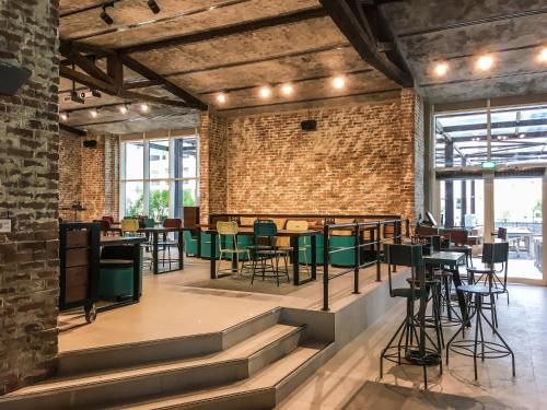 a room with a brick wall and tables and chairs at Citymax Hotel Business Bay in Dubai