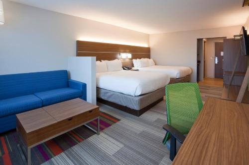 a hotel room with a bed and a couch at Holiday Inn Express & Suites Minneapolis - West End by IHG in Minneapolis