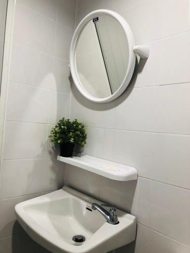 a bathroom with a sink and a mirror on the wall at NK Guesthouse 2 in Bangkok