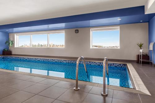 a swimming pool in a hotel with two windows at Ramada Plaza by Wyndham Dubai Deira in Dubai
