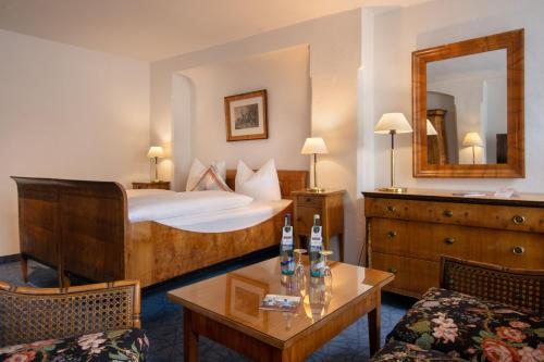 a hotel room with a bed and a table at Posthotel Kolberbräu in Bad Tölz