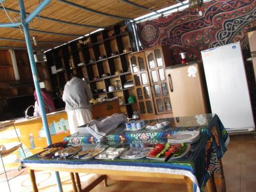 a kitchen with a table with food on it at Bet El Kerem Guesthouse in Aswan